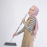 A young muslim beautiful housewife smiling on white background